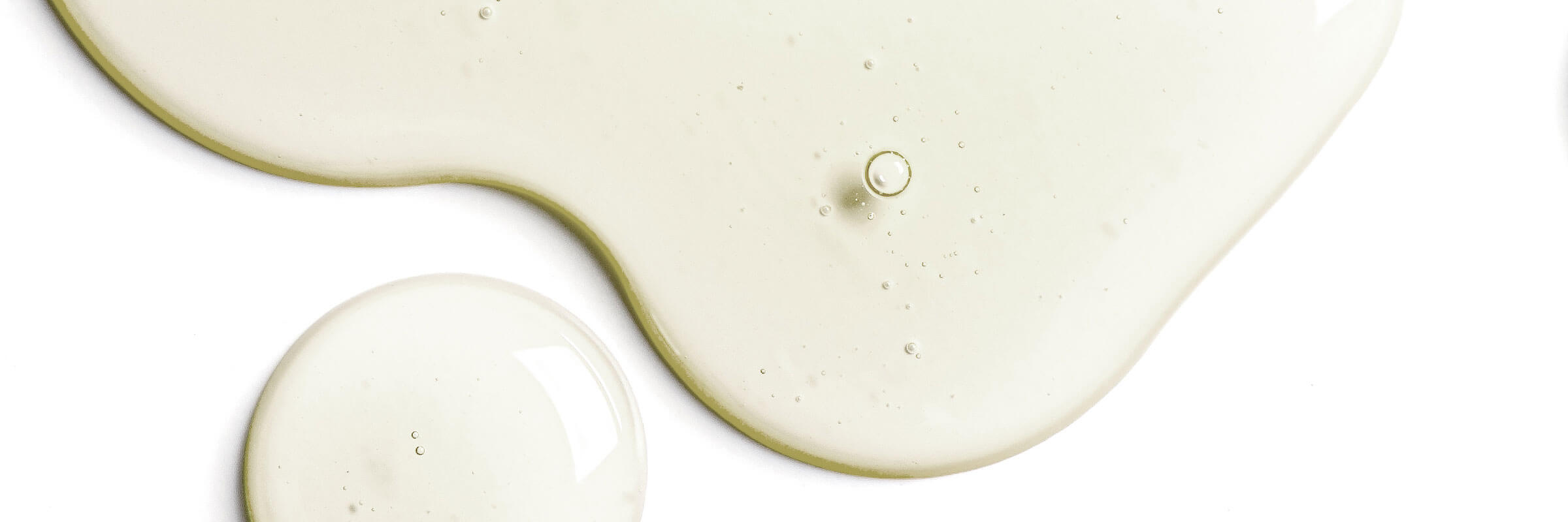 Clear hyaluronic acid serum gel swatched across a pale surface