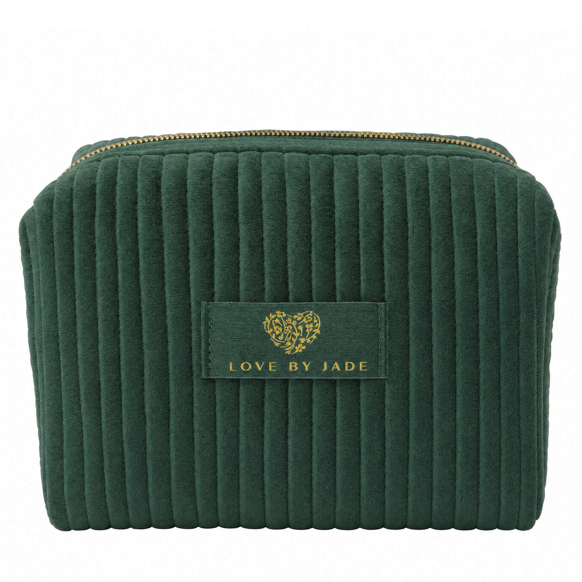 The Velvet Beauty Bag in deep green ribbed velvet, zipped closed, with a gold zipper and a gold embroidered Love by Jade heart logo on the front label.