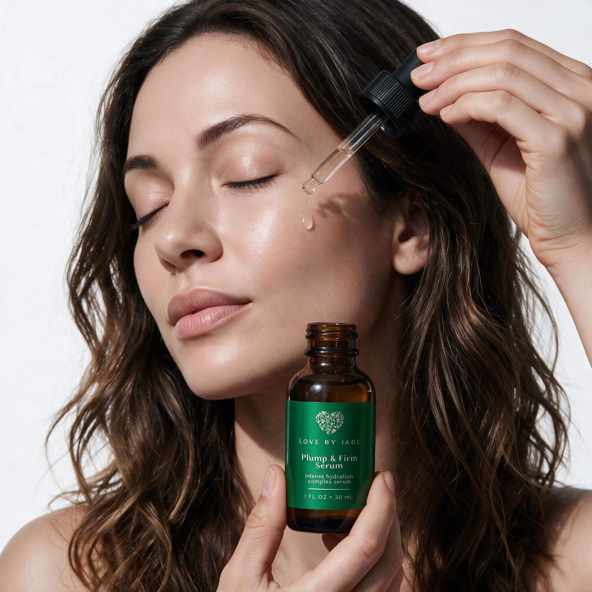 Woman pressing a drop of Plump & Firm Peptide Powerhouse Serum into her cheek with the glass dropper, holding the amber 30ml bottle.